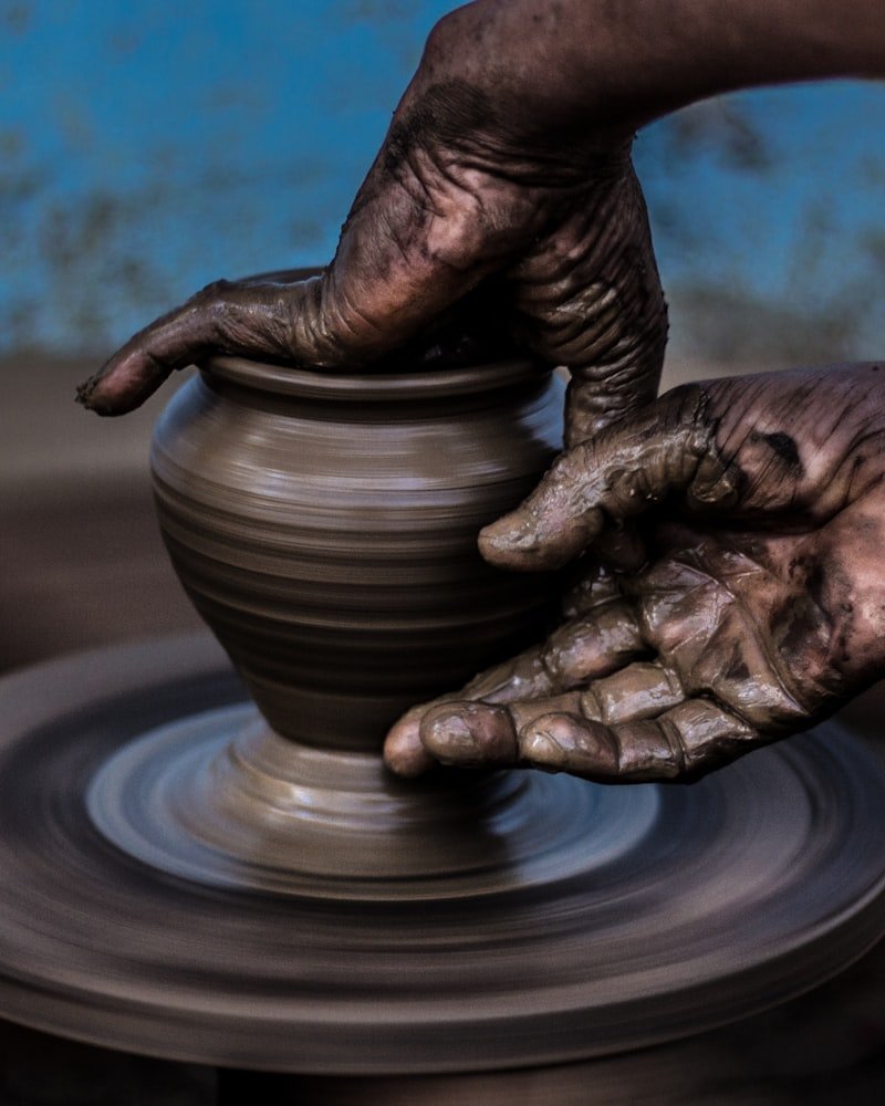 Potter's hands shaping wet clay on a spinning wheel at the LocalWorkshops.ca Ottawa studio